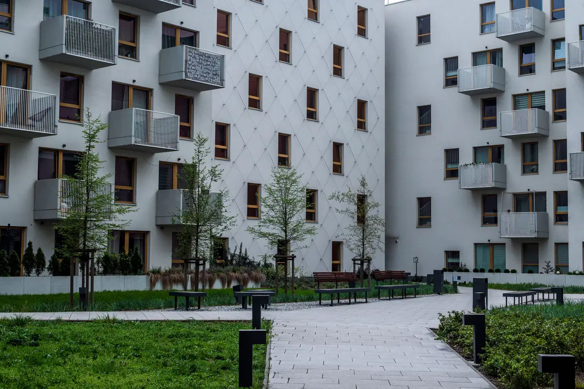 A managed apartment development with a shared landscaped courtyard between blocks