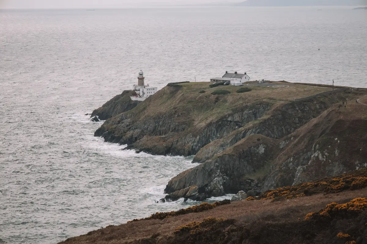 Baily Lighthouse on the rocky headland at Howth, with open sea beyond