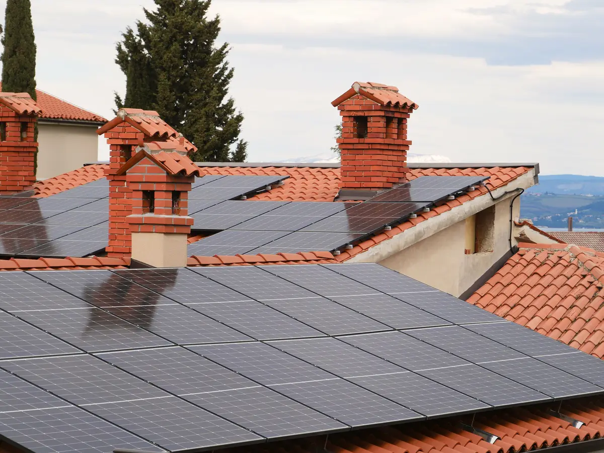 Solar panels installed across several residential tiled roofs