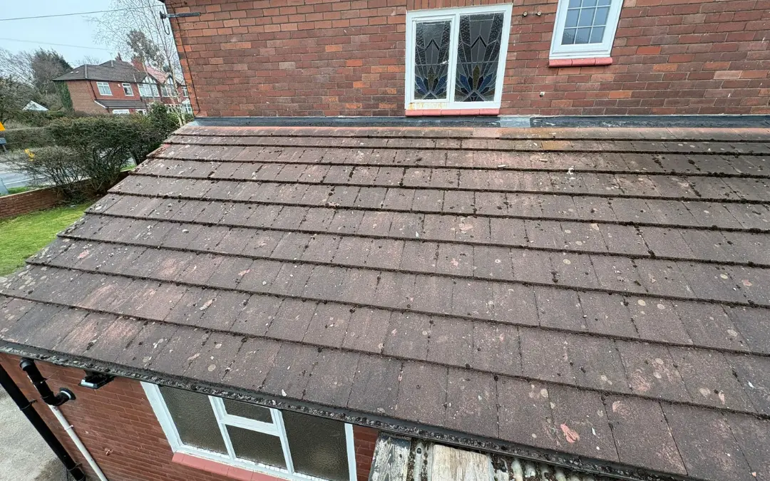 A darkly stained concrete tile roof before cleaning